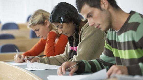 three students taking a test resized
